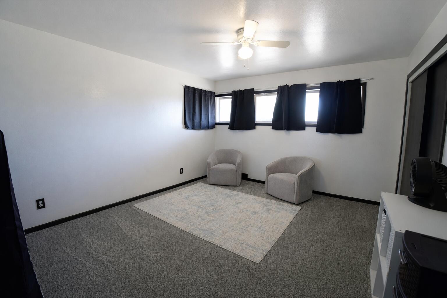 730 South 17th Street Slaton, TX 79364 - Photo 16 of 23 a living room with furniture and a flat screen tv