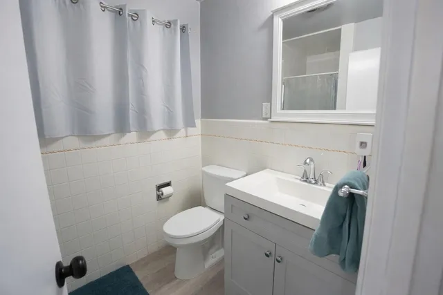 a bathroom with a toilet sink and mirror