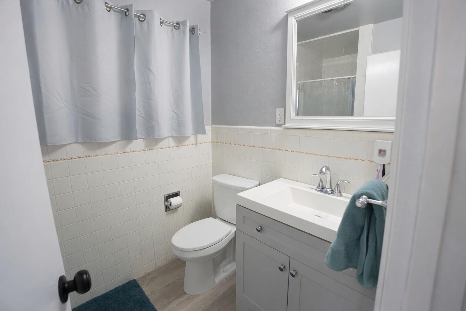 730 South 17th Street Slaton, TX 79364 - Photo 17 of 23 a bathroom with a toilet sink and mirror