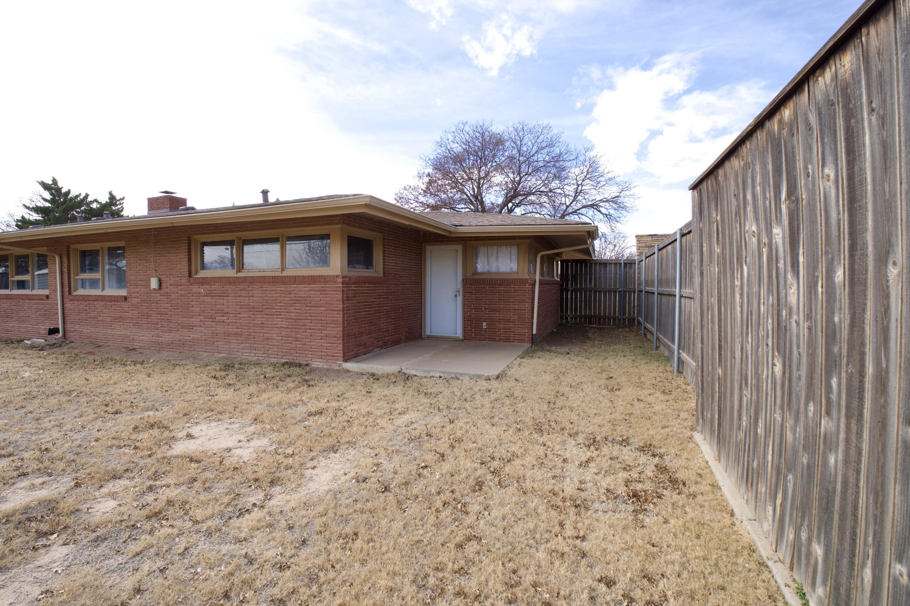 730 South 17th Street Slaton, TX 79364 - Photo 22 of 23 a view of a house with a backyard