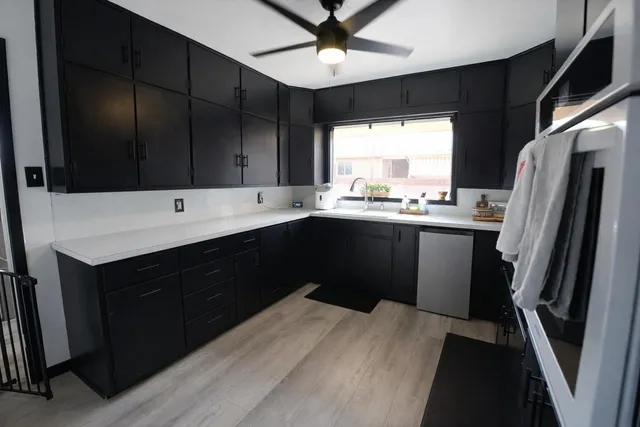 a kitchen with a sink a refrigerator and window
