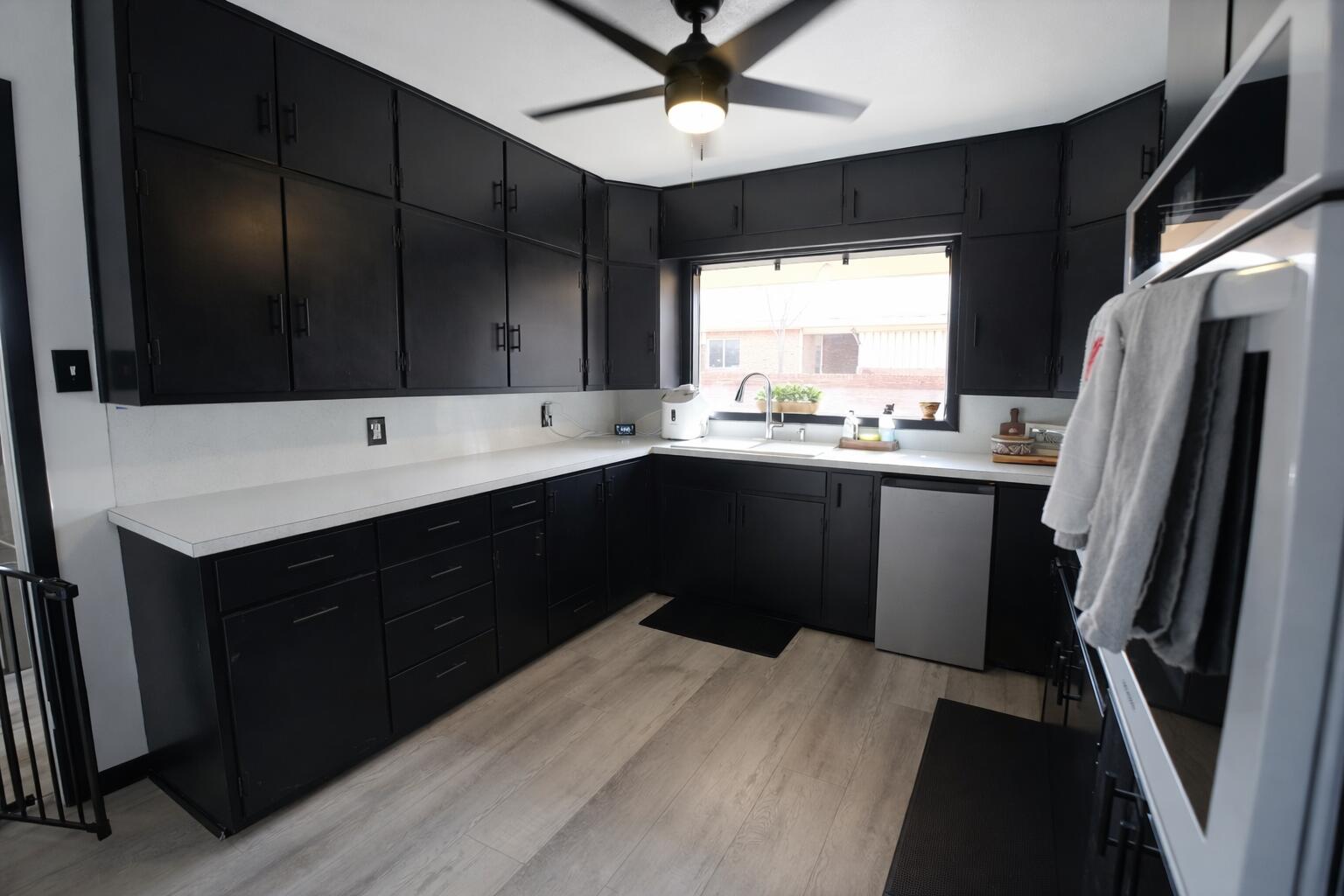 730 South 17th Street Slaton, TX 79364 - Photo 5 of 23 a kitchen with a sink a refrigerator and window