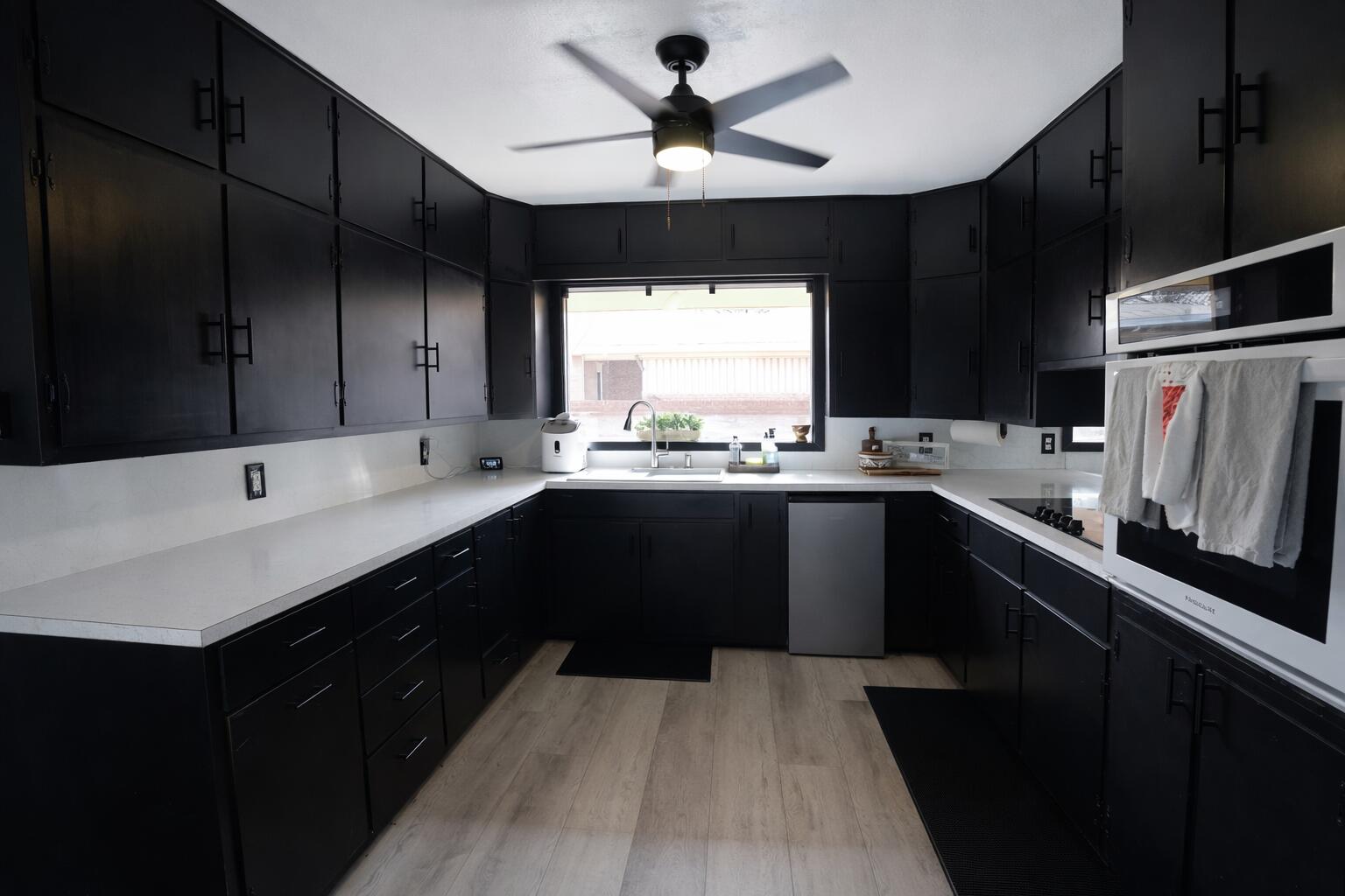 730 South 17th Street Slaton, TX 79364 - Photo 7 of 23 a kitchen with a sink a window and stainless steel appliances
