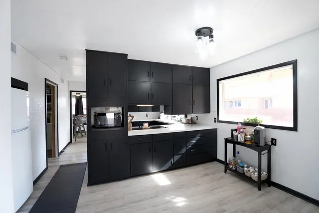 a kitchen with stainless steel appliances granite countertop a sink and a stove