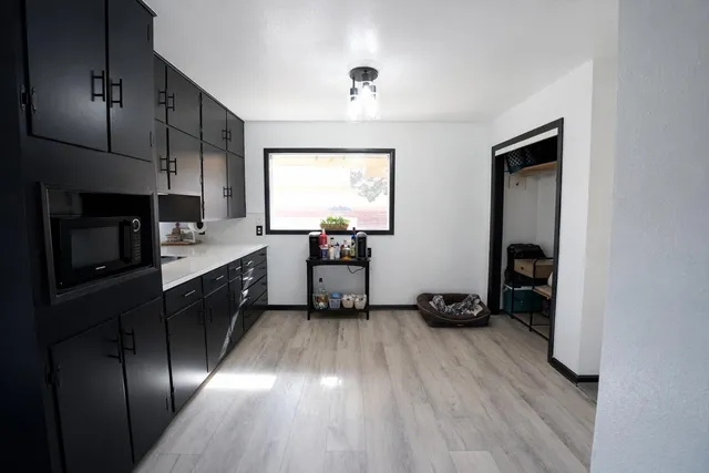 a kitchen with sink cabinets and stainless steel appliances