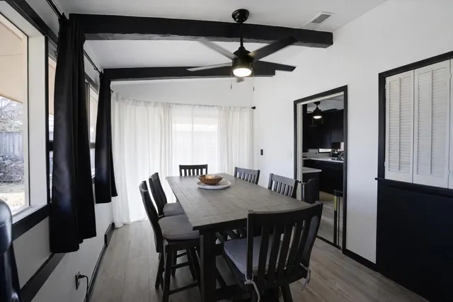 a view of a dining room with furniture and a window