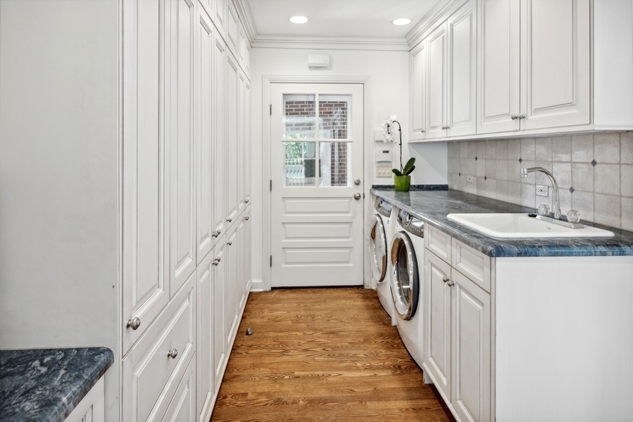473 Sheridan Road Winnetka, IL 60093 - Photo 11 of 32 a kitchen with granite countertop a sink stove and cabinets