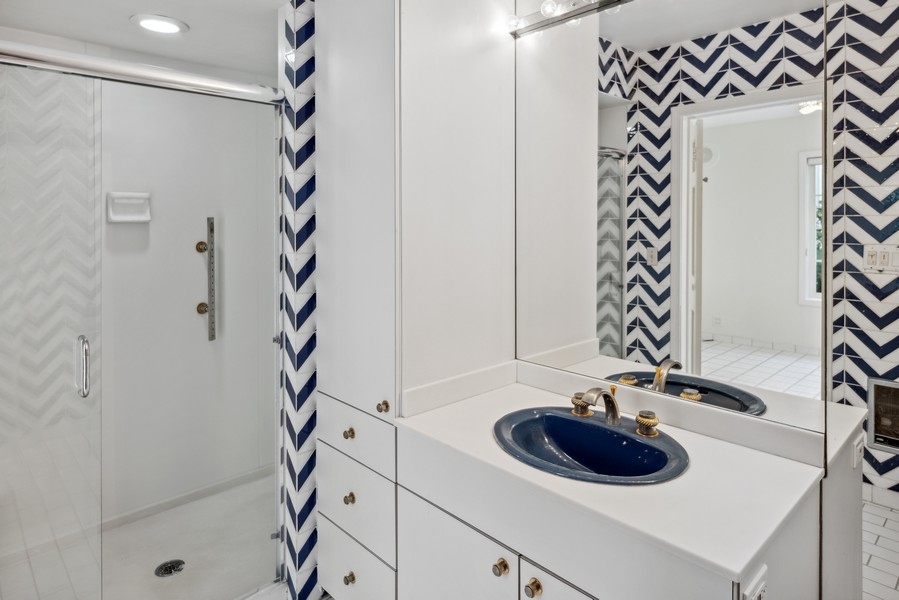 473 Sheridan Road Winnetka, IL 60093 - Photo 15 of 32 a bathroom with a sink and a mirror