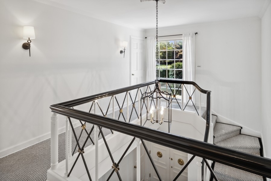 473 Sheridan Road Winnetka, IL 60093 - Photo 17 of 32 a view of a hallway with wooden floor and staircase