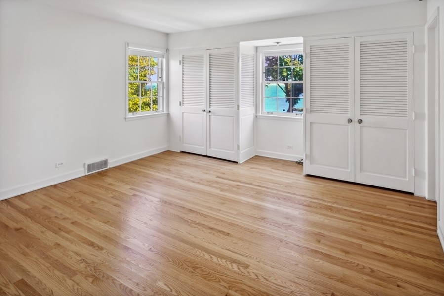 473 Sheridan Road Winnetka, IL 60093 - Photo 21 of 32 an empty room with windows and wooden floor