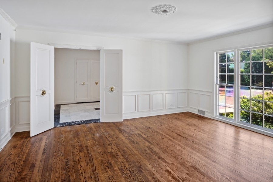 473 Sheridan Road Winnetka, IL 60093 - Photo 5 of 32 a view of empty room with wooden floor and fan
