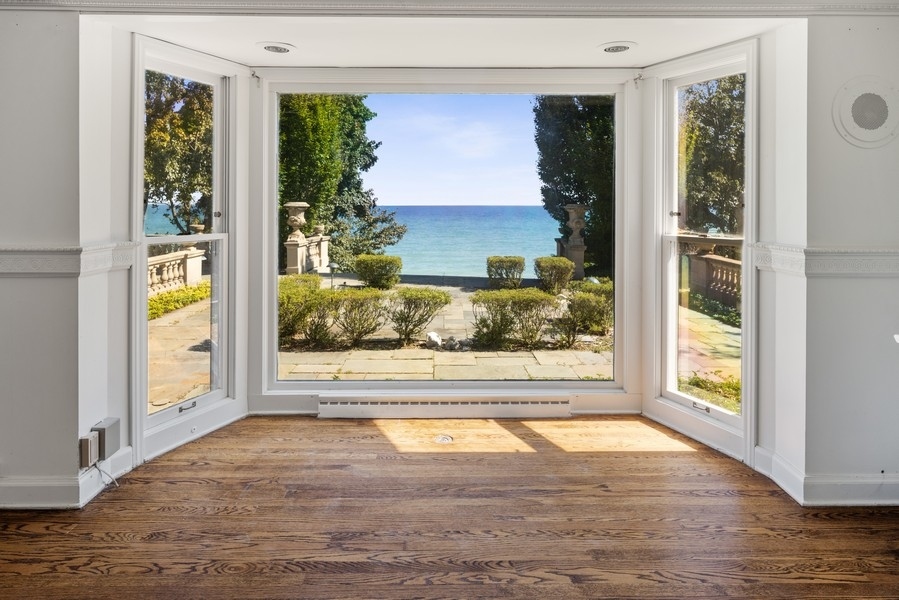473 Sheridan Road Winnetka, IL 60093 - Photo 7 of 32 a view of a room that has a large window and wooden floor