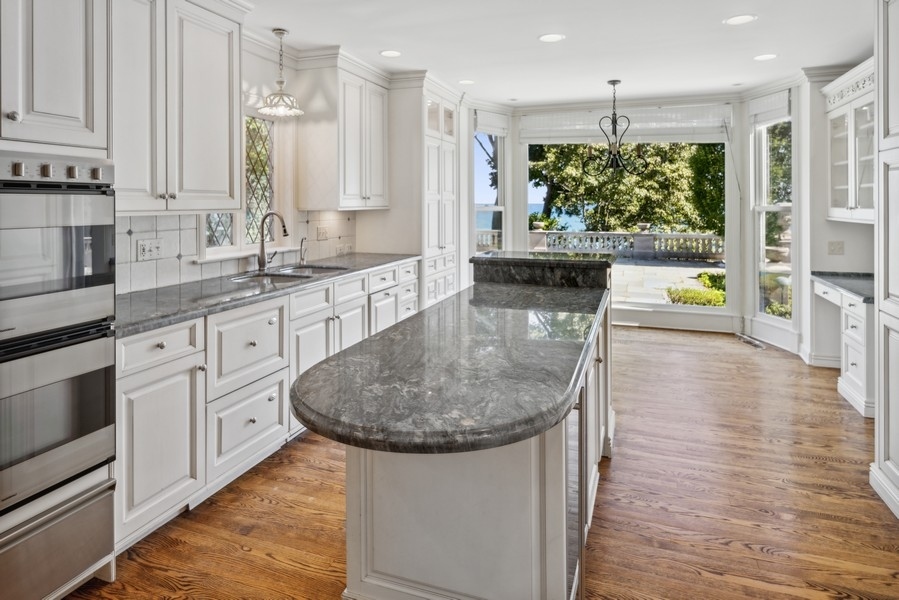 473 Sheridan Road Winnetka, IL 60093 - Photo 9 of 32 a kitchen with stainless steel appliances granite countertop a sink a stove and cabinets