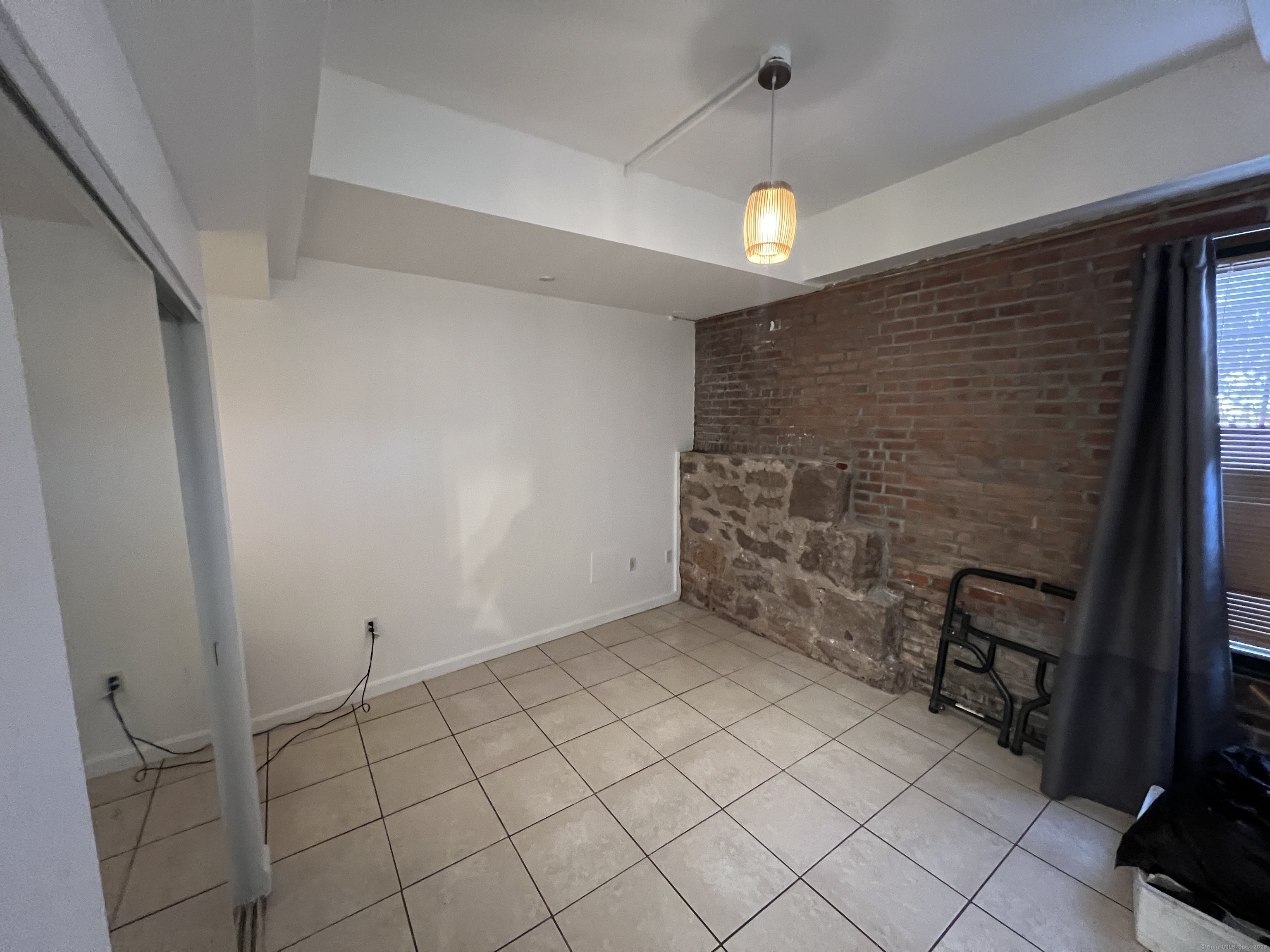 1 Front Street, Unit 1 New Haven, CT 06513 - Photo 12 of 23 a view of an empty room with wooden floor and chandelier
