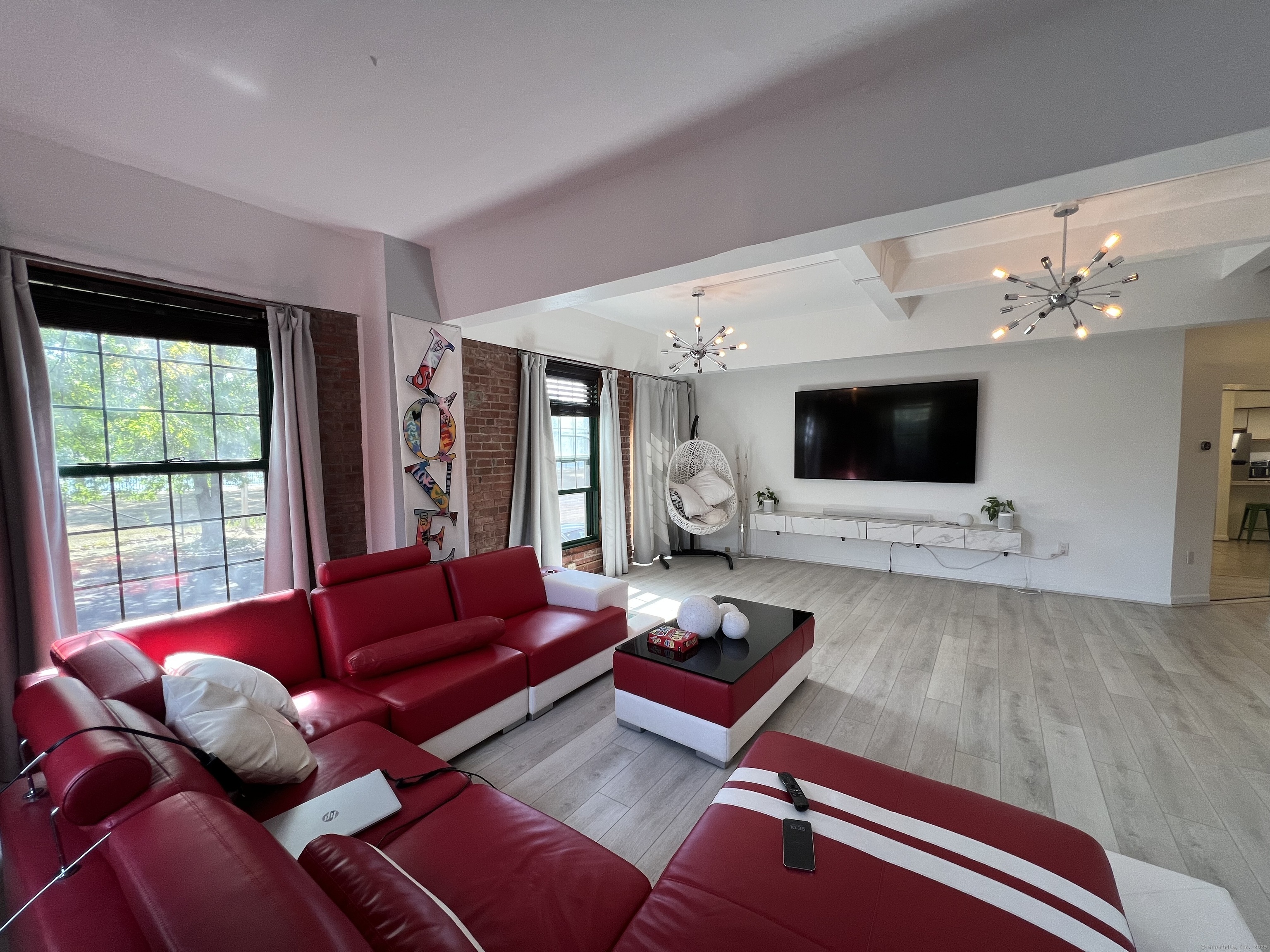 1 Front Street, Unit 1 New Haven, CT 06513 - Photo 18 of 23 a living room with furniture and a flat screen tv