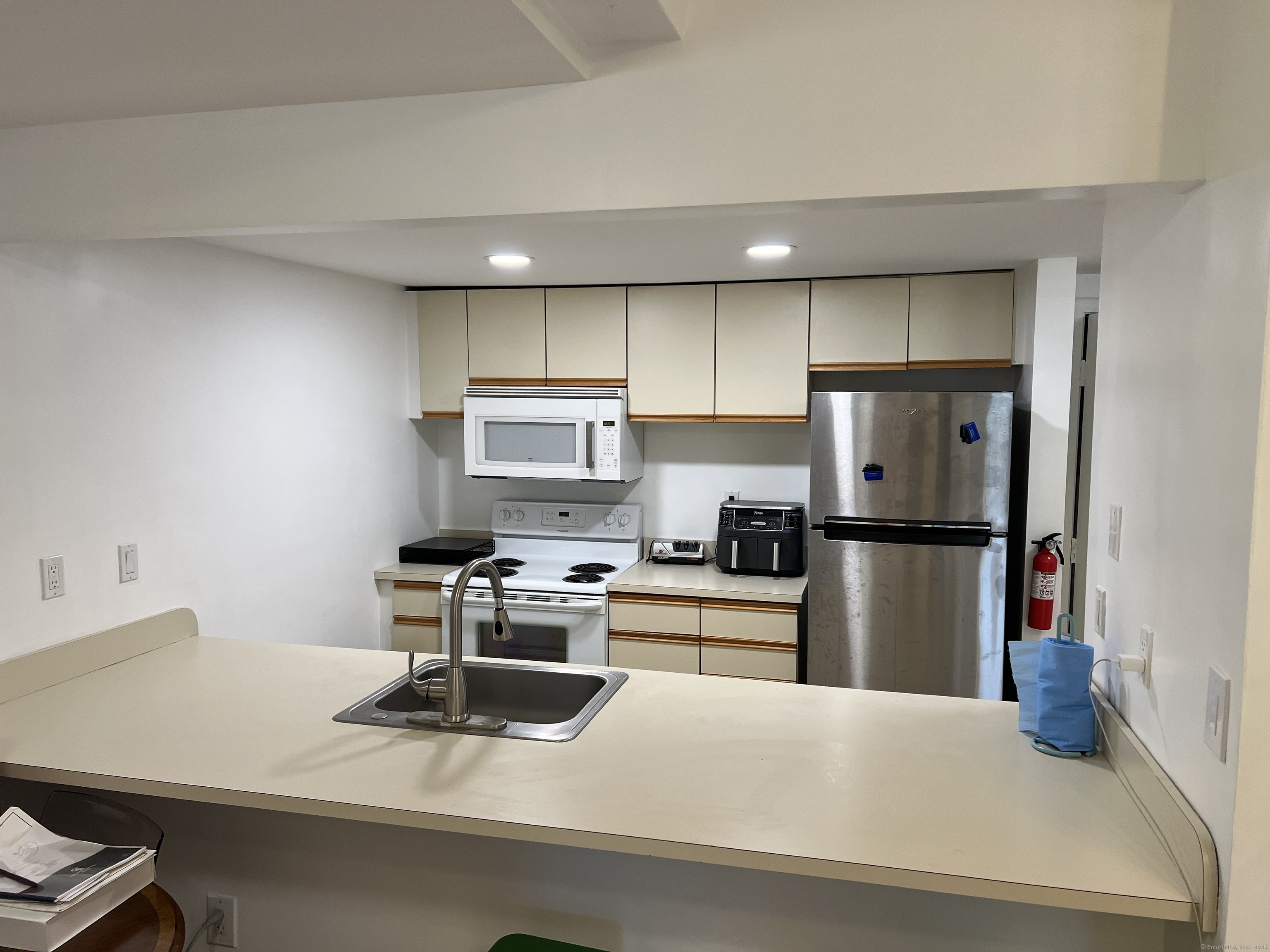 1 Front Street, Unit 1 New Haven, CT 06513 - Photo 5 of 23 a kitchen with a refrigerator a stove and white cabinets