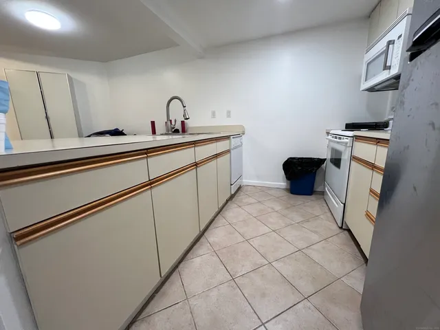 a kitchen with a sink cabinets and appliances