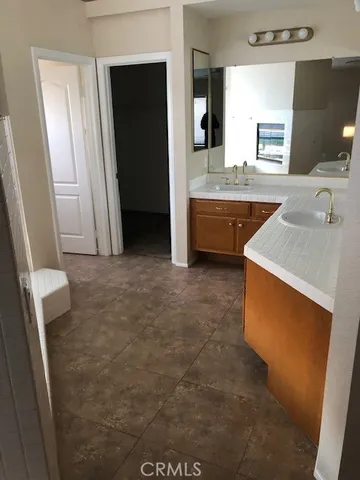 a bathroom with a sink a mirror and a bathtub