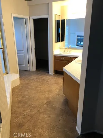 a bathroom with a tub sink and mirror