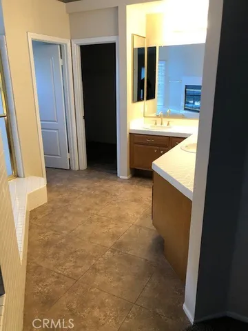 a bathroom with a tub sink and mirror