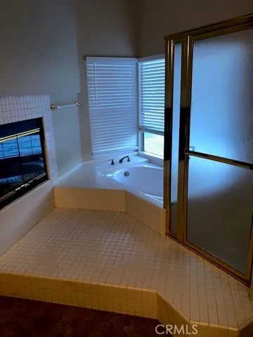 a bathroom with a tub and a shower