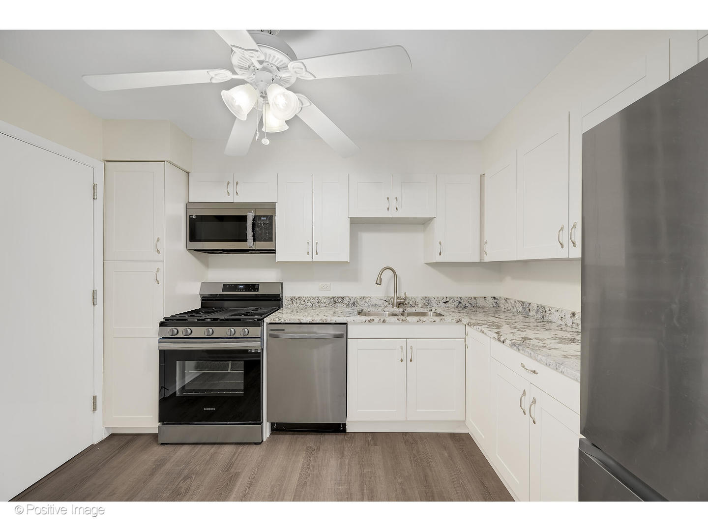 10377 Dearlove Road, Unit 5205 Glenview, IL 60025 - Photo 11 of 23 a kitchen with stainless steel appliances granite countertop a stove a sink dishwasher and a refrigerator