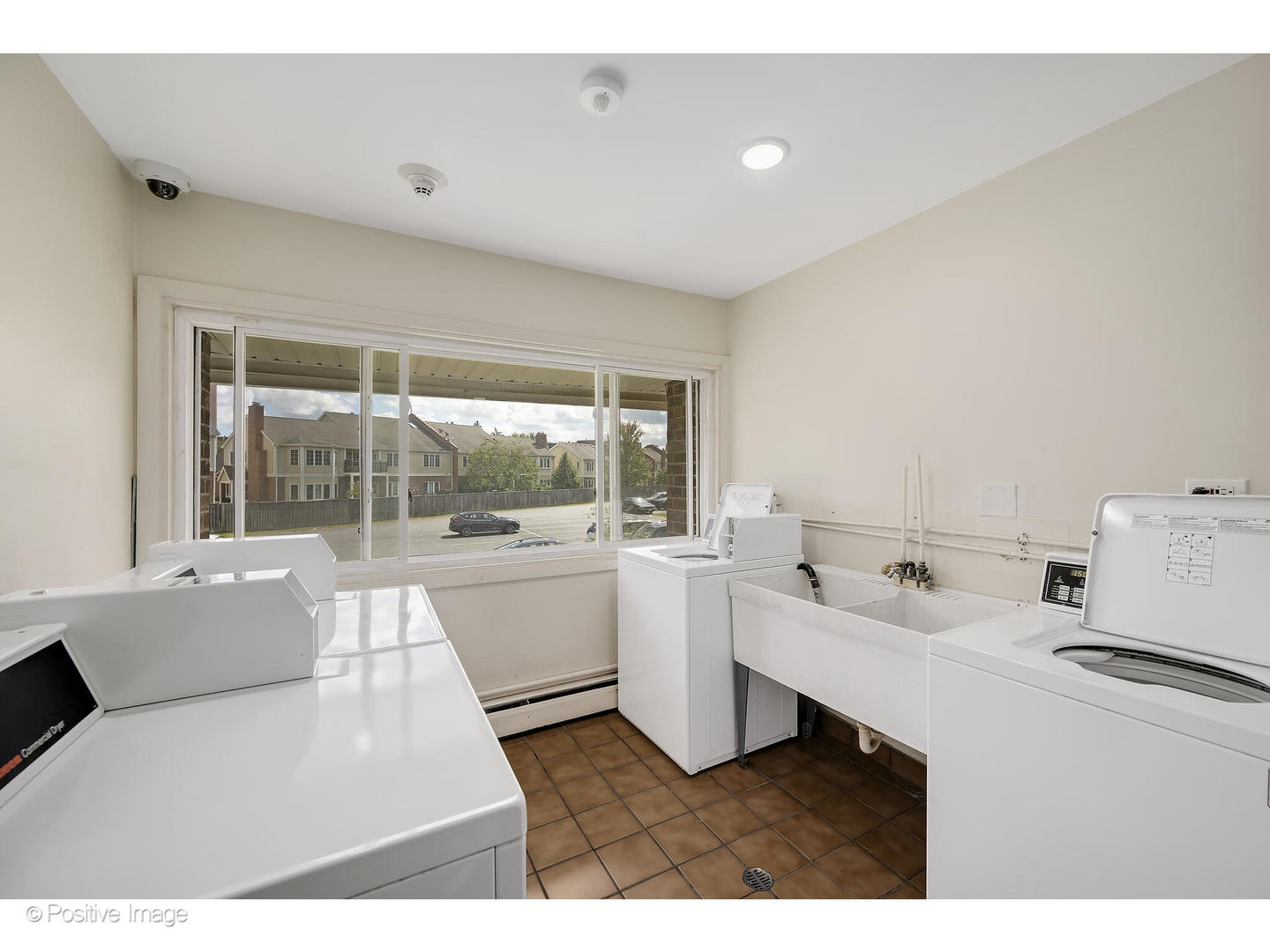 10377 Dearlove Road, Unit 5205 Glenview, IL 60025 - Photo 17 of 23 a open kitchen with white cabinets and white appliances