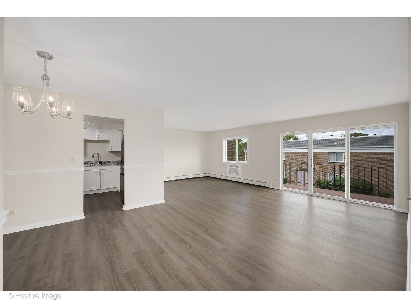 10377 Dearlove Road, Unit 5205 Glenview, IL 60025 - Photo 4 of 23 a view of an empty room with window and wooden floor