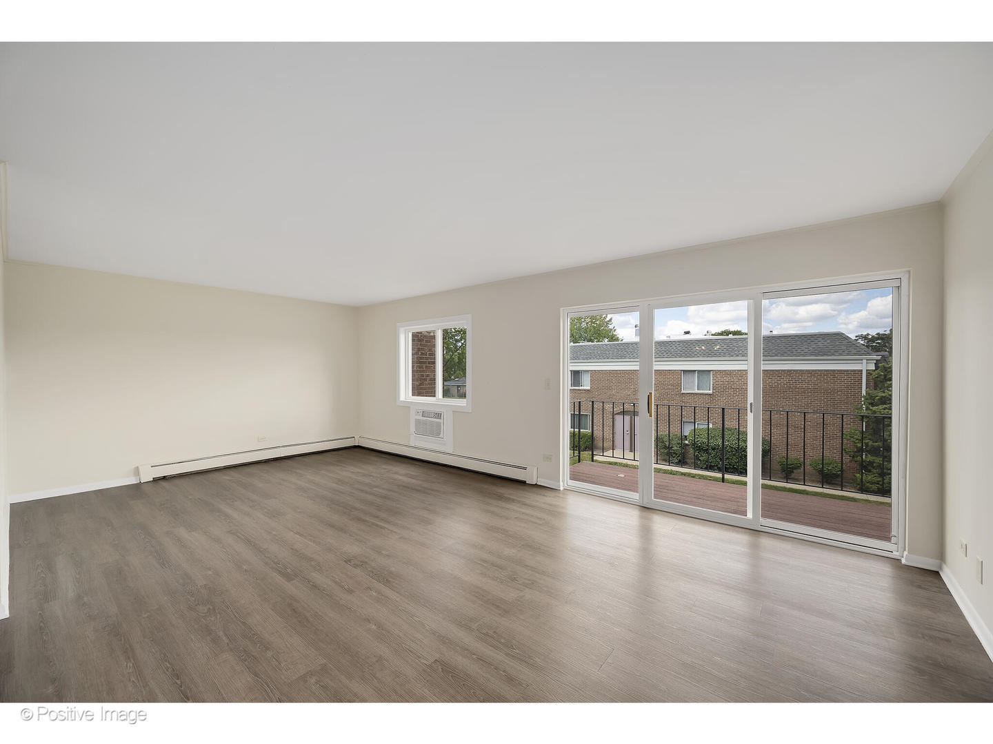 10377 Dearlove Road, Unit 5205 Glenview, IL 60025 - Photo 6 of 23 a view of an empty room with wooden floor and a window