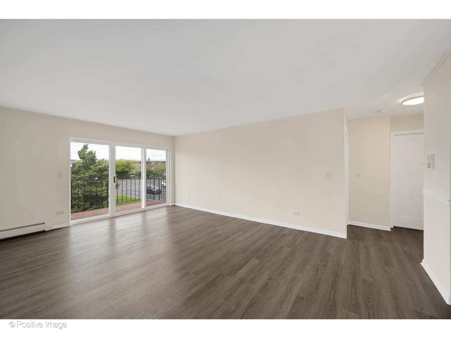 10377 Dearlove Road, Unit 5205 Glenview, IL 60025 - Photo 7 of 23 a view of an empty room with wooden floor and a large window