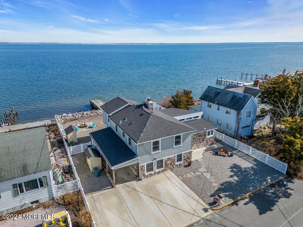 an aerial view of a house with ocean view