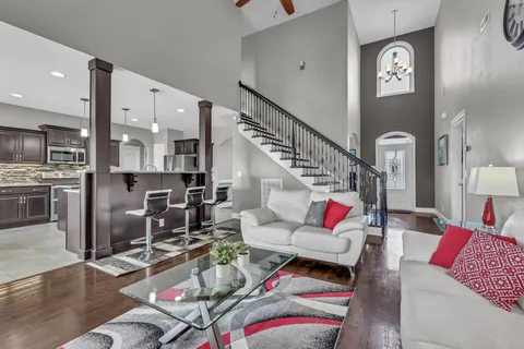 a living room with furniture and wooden floor