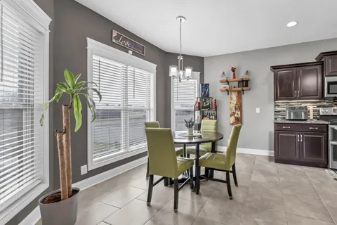 a view of a dining room with furniture and a window