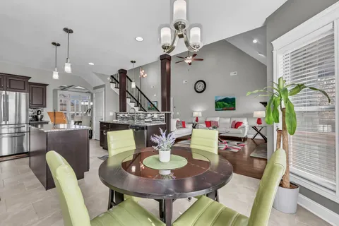 a dining room with furniture and wooden floor