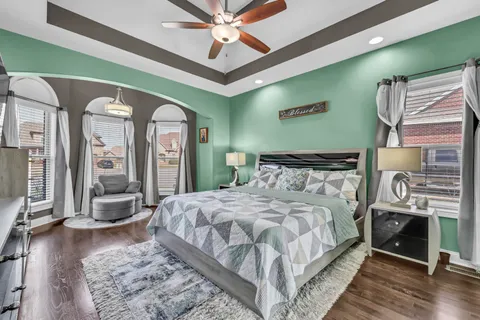 a bedroom with a large bed and a chandelier