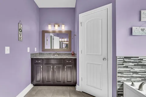 a view of a bathroom with a sink and mirror