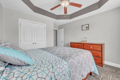 a bathroom with a granite countertop sink mirror vanity and toilet