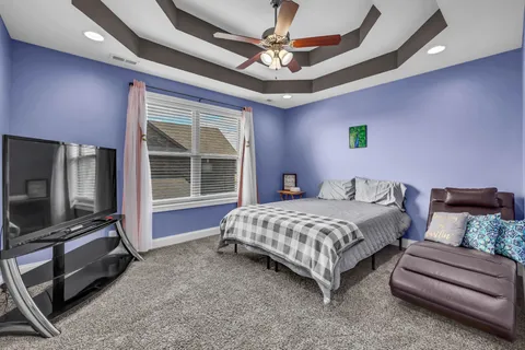 a bedroom with bed and window