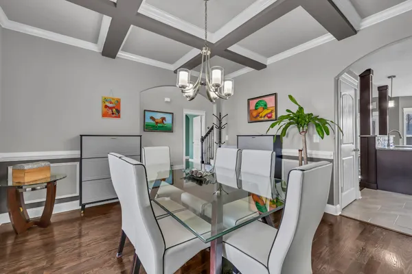 a view of a dining room with furniture wooden floor and chandelier