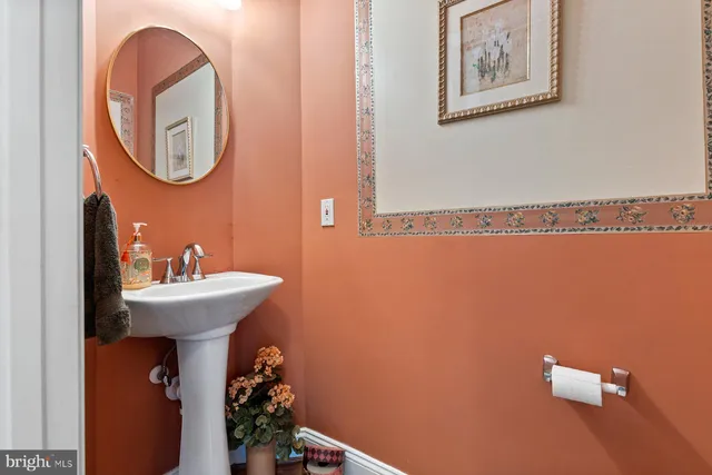 a bathroom with a sink mirror and toilet