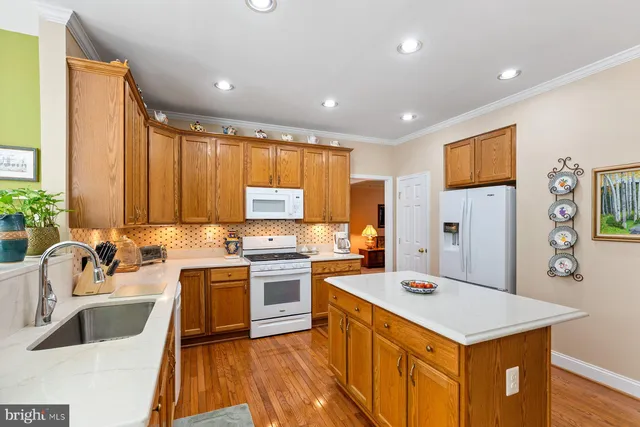 a kitchen with a sink stove and refrigerator