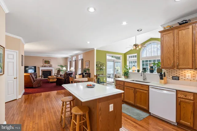 a large kitchen with sink a refrigerator a stove a dining table and chairs