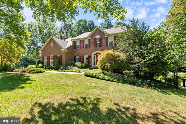 a front view of a house with yard and green space