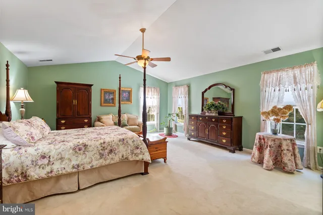 a bedroom with bed and a chandelier