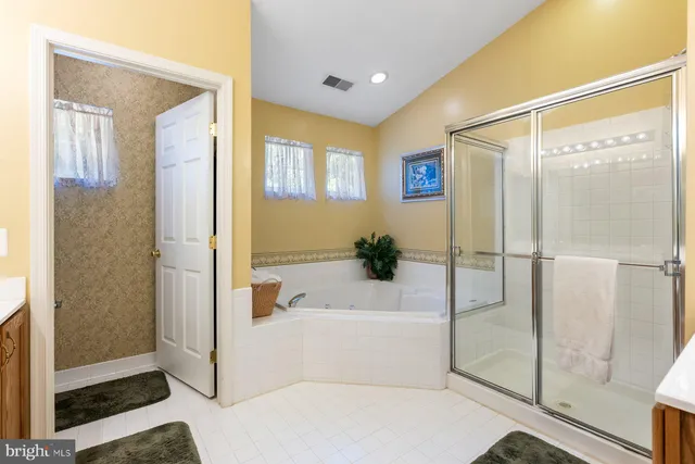 a bathroom with a tub and shower