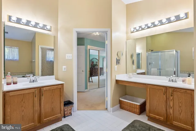 a bathroom with a sink double vanity and a mirror