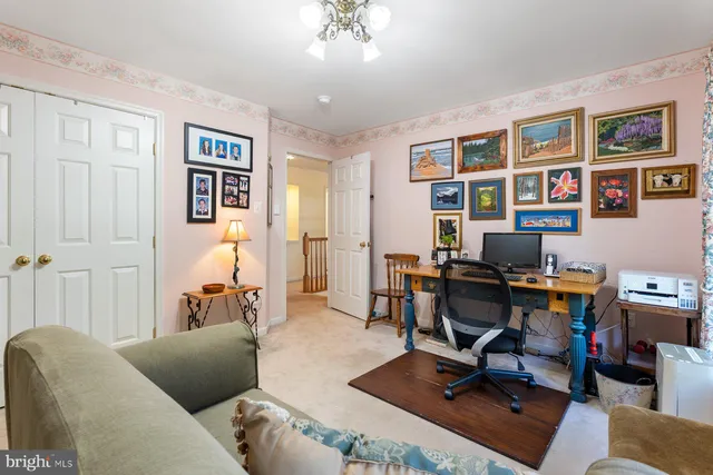 a view of a livingroom with workspace and a couch
