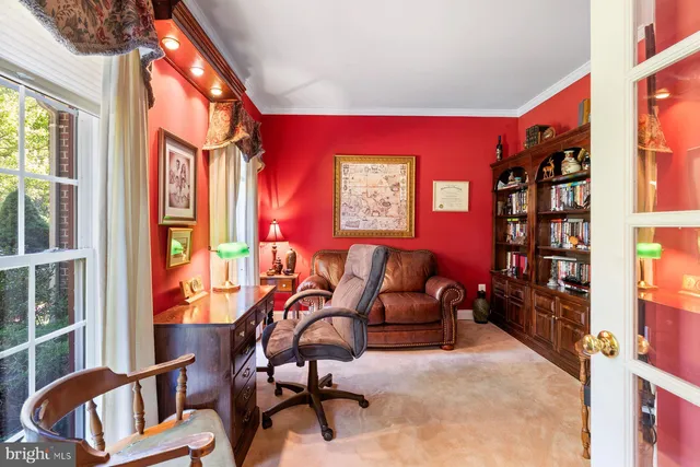 a living room with furniture a large window and bookshelf