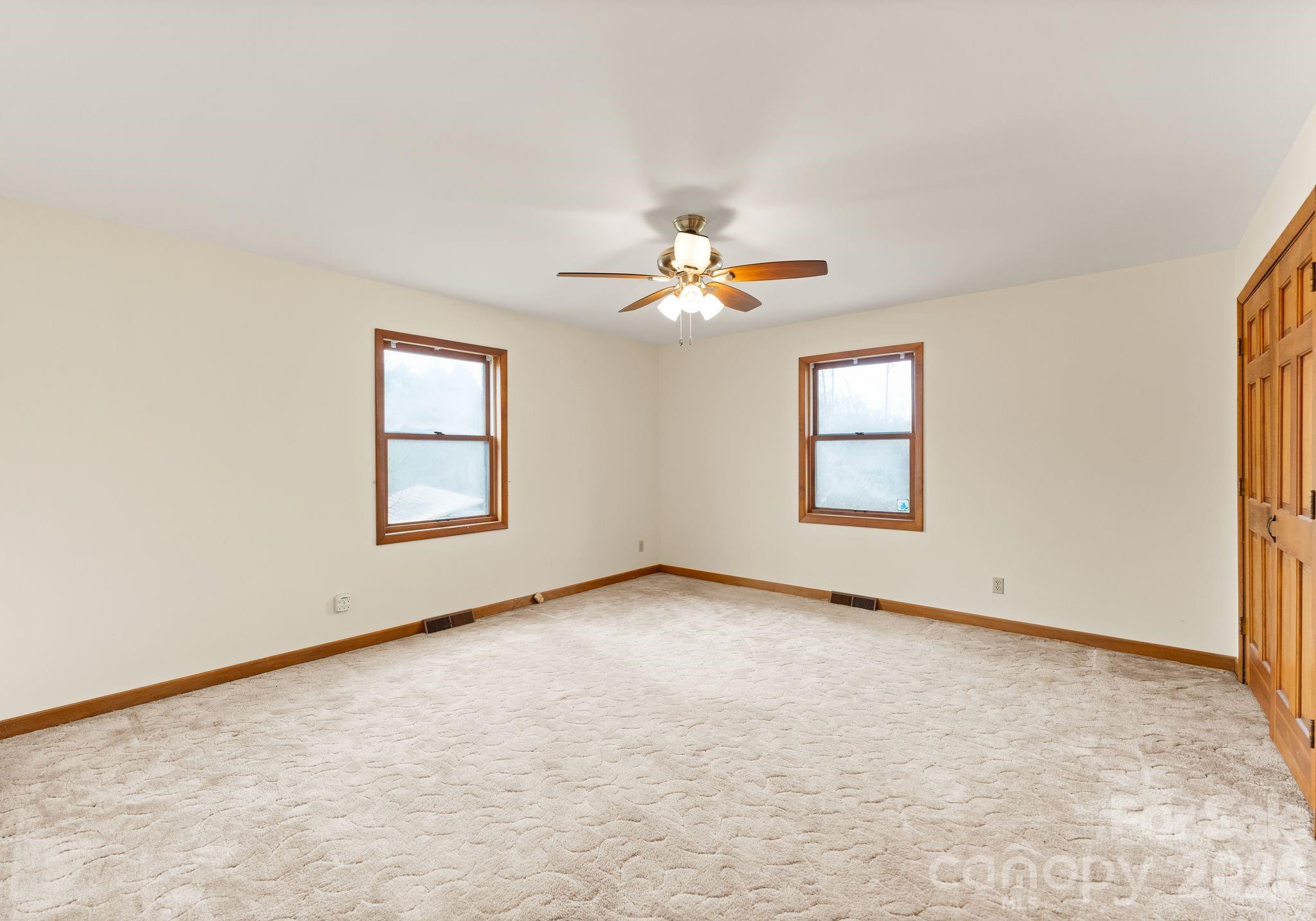 150 Barber Lyerly Road Salisbury, NC 28147 - Photo 20 of 43 an empty room with windows and chandelier fan