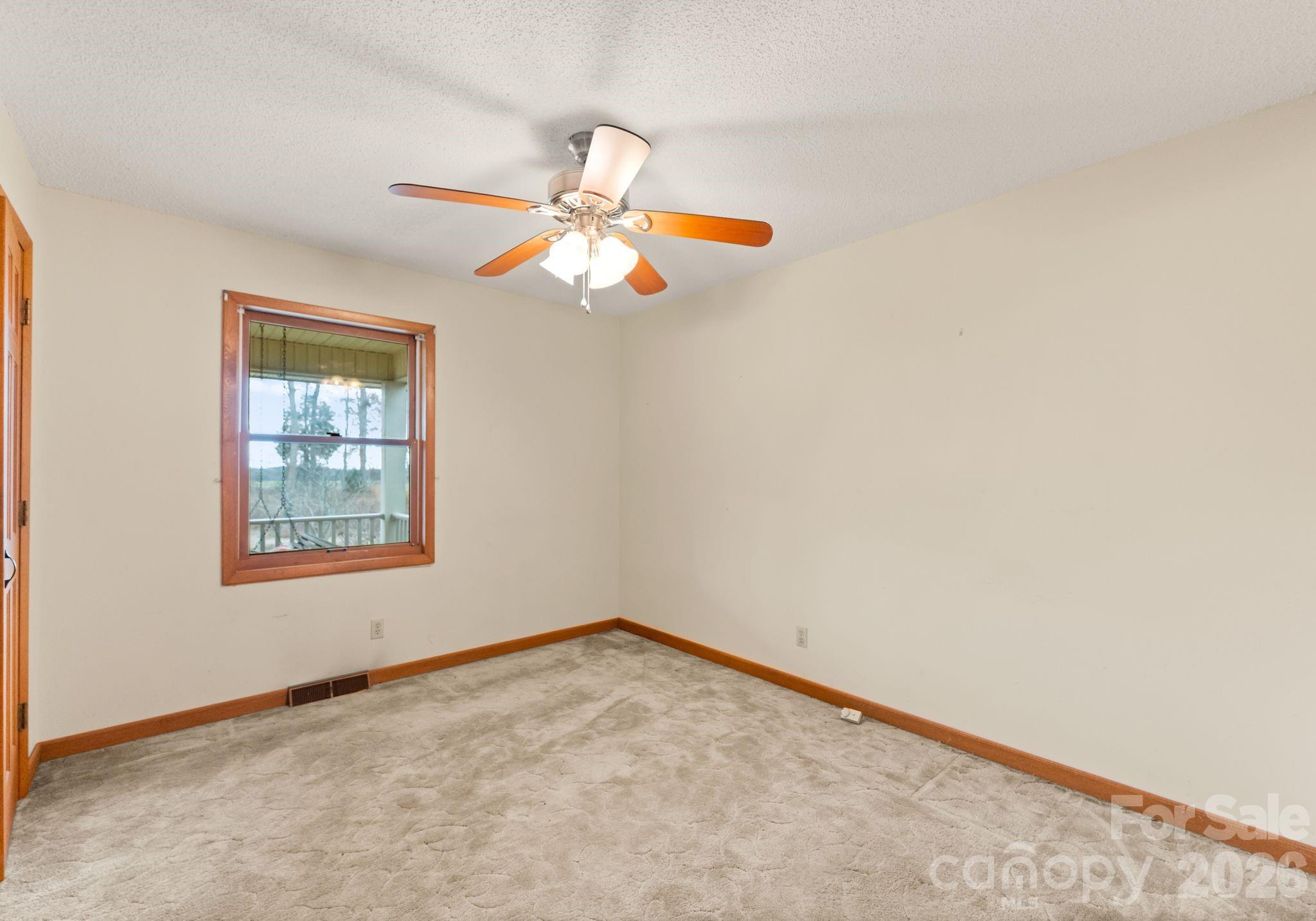 150 Barber Lyerly Road Salisbury, NC 28147 - Photo 21 of 43 an empty room with a window and a fan